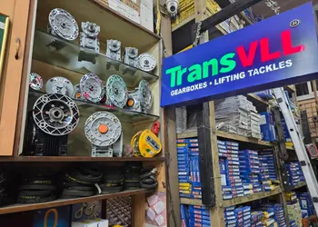 OEM-labelled gearbox and chain boxes on warehouse shelving